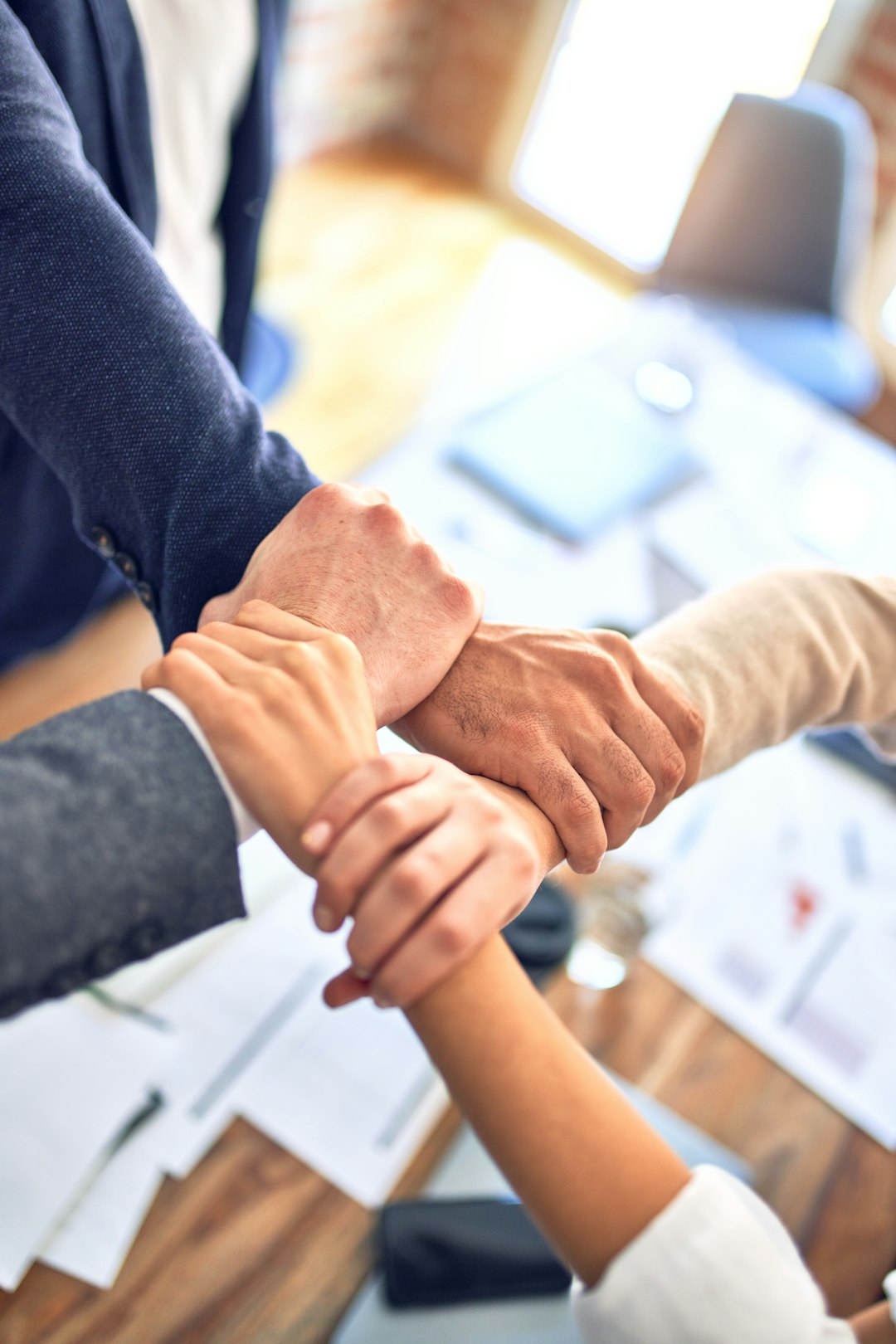 Mastering the First Impression: Your intriguing post title goes here Group of business workers standing with hands together doing symbol at the office